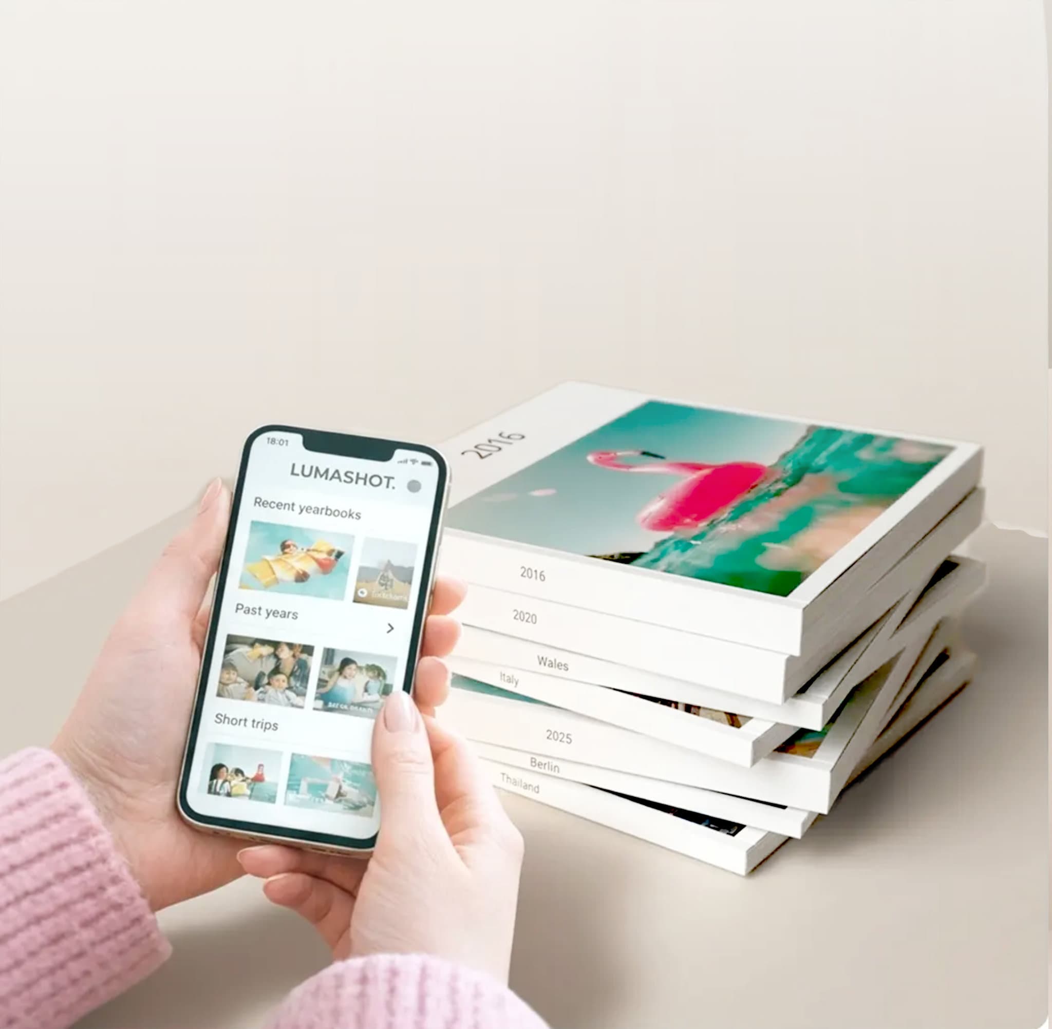 Lumashot app with a stack of printed photo books