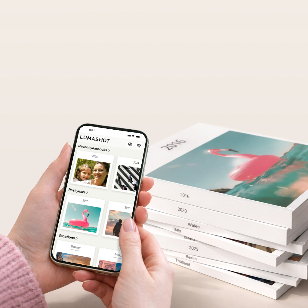 Lumashot app with a stack of printed photo books